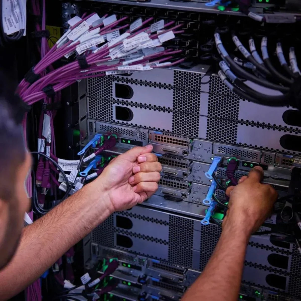 Technician performing comprehensive 50+ point hardware stability and electrical testing on Lenovo refurbished server rack